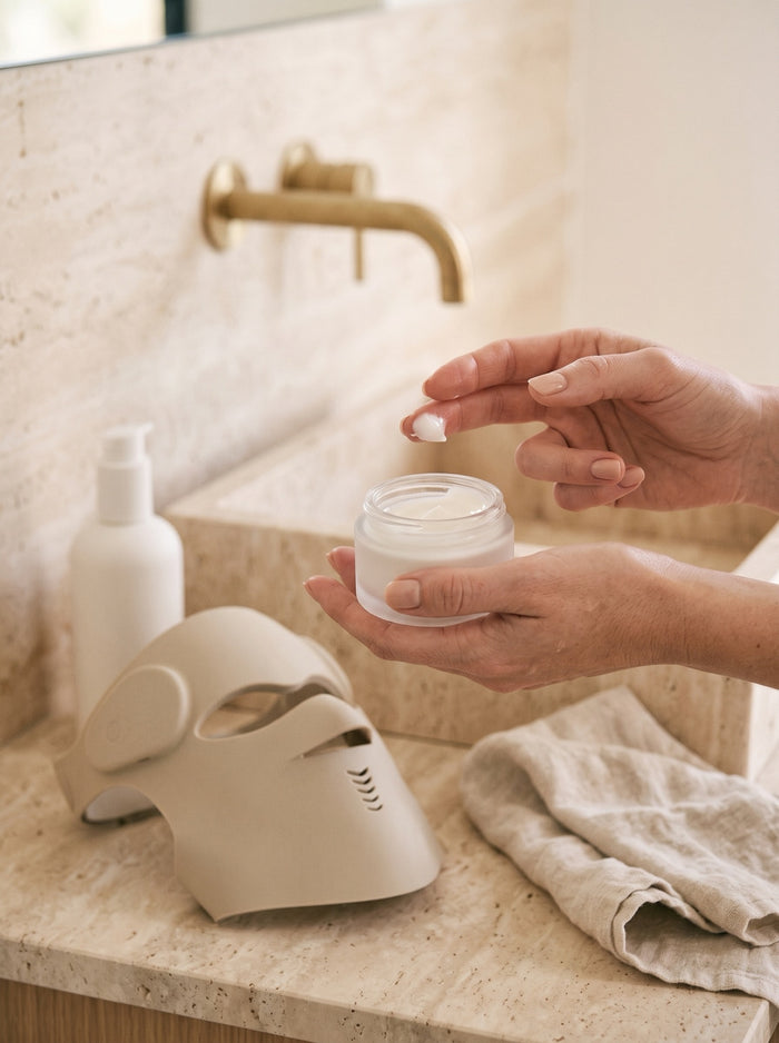 Manos con un tarro de crema hidratante para sellar el ritual